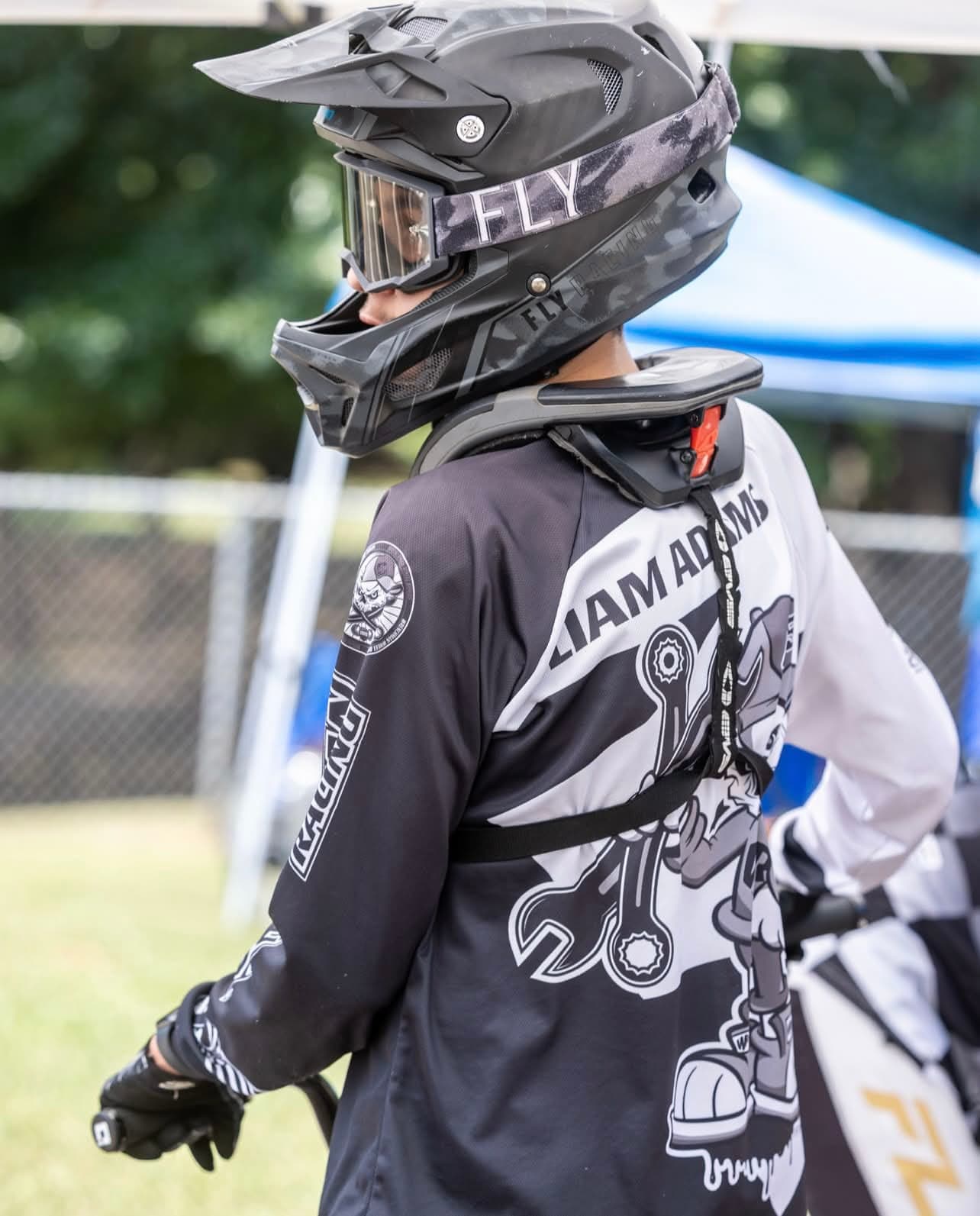 Liam in his LIAM ADAMS race jersey with helmet on