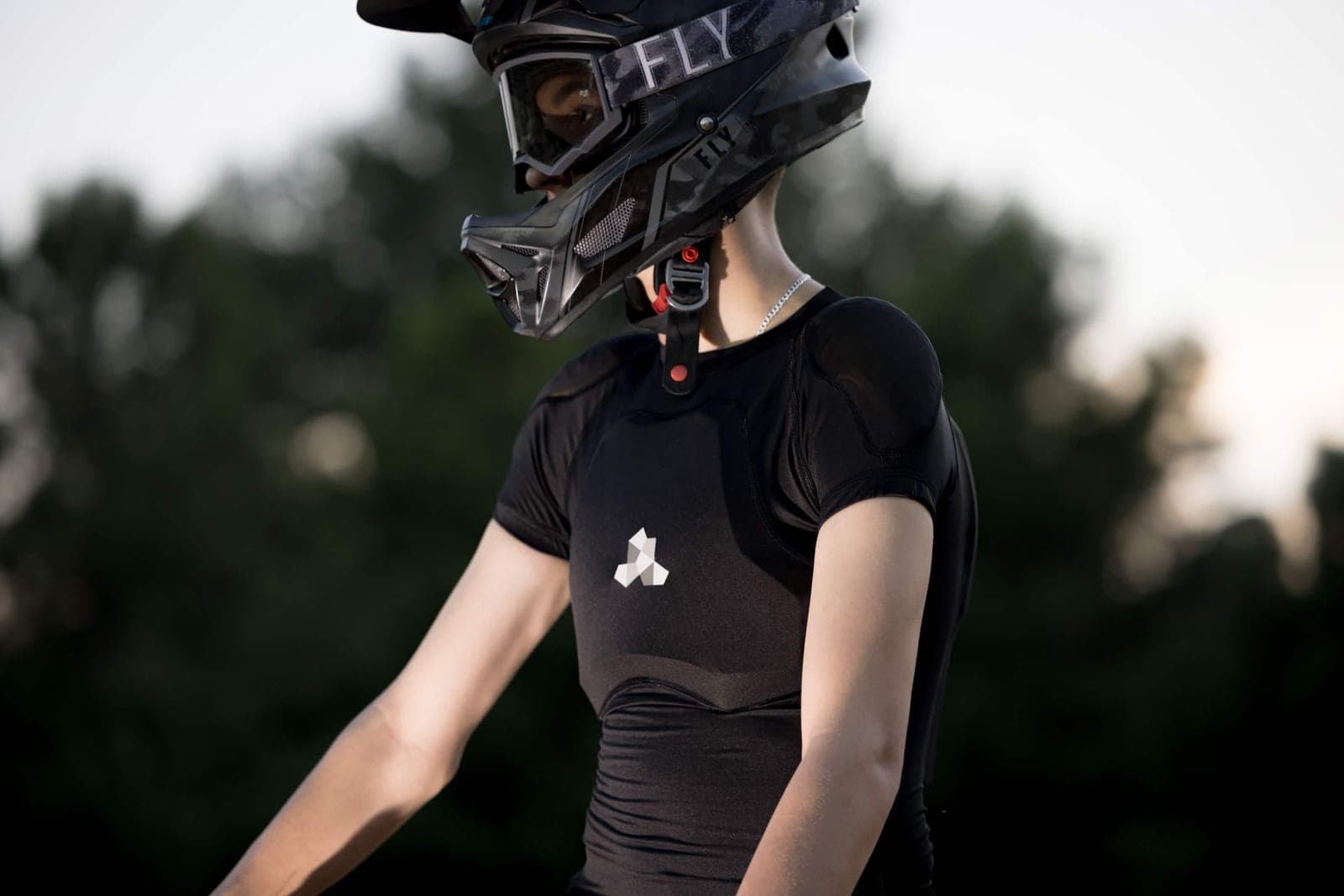 Liam in helmet and compression shirt at golden hour
